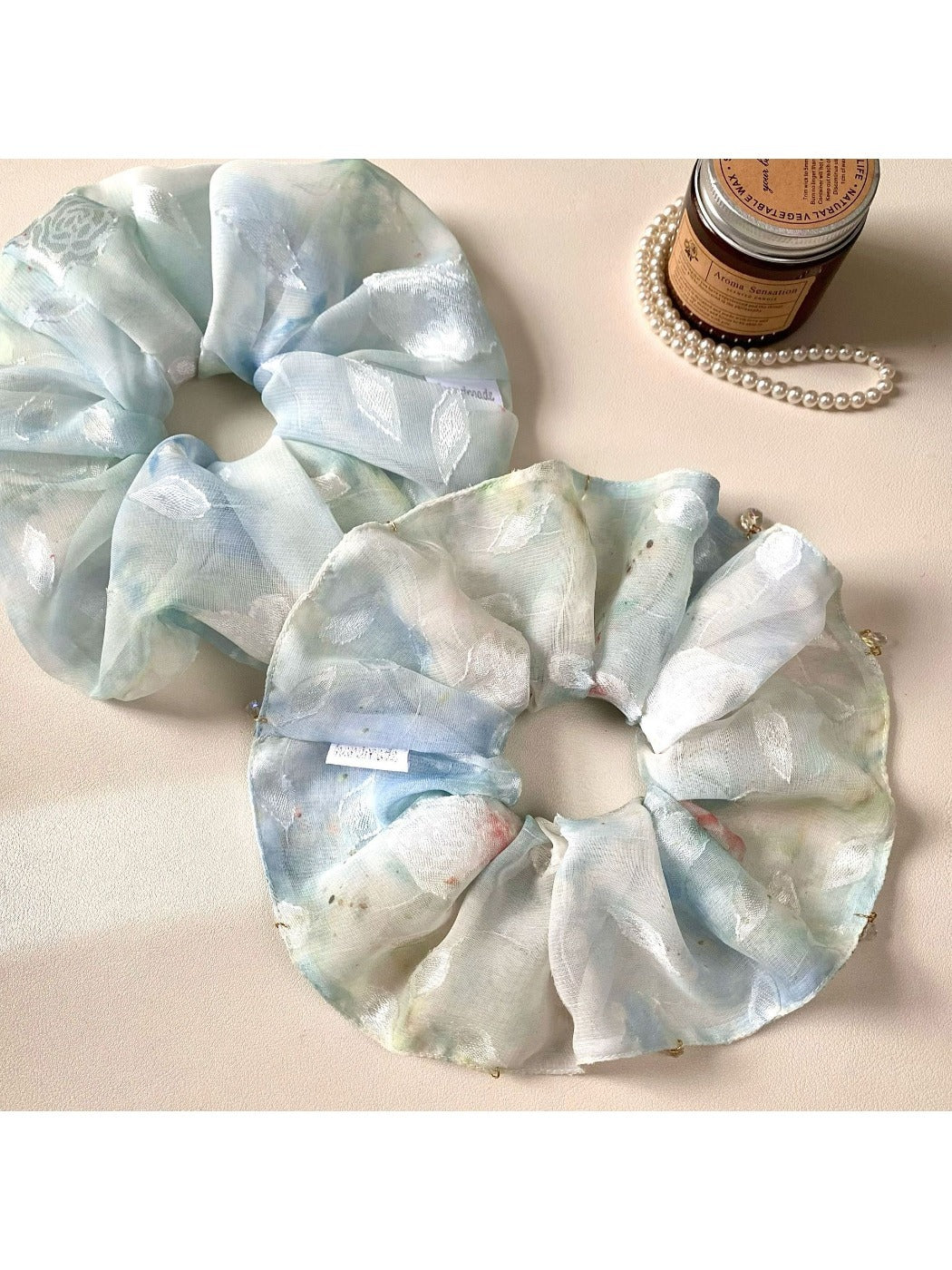 Close-up of Gifty natural pure blue scrunchie made from soft fabric
