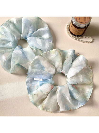 Close-up of Gifty natural pure blue scrunchie made from soft fabric