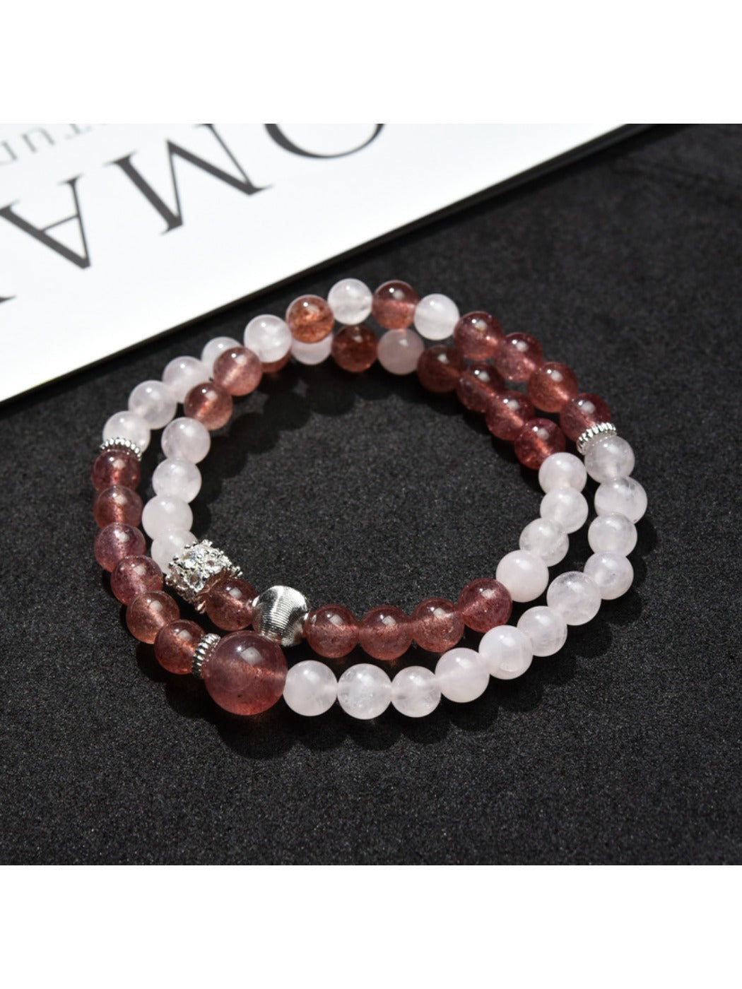 Close-up of Lovra color block bracelet showing smooth round beads in neutral tones