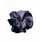 Gifty scrunchie wrapped around a ponytail on a model with brown hair