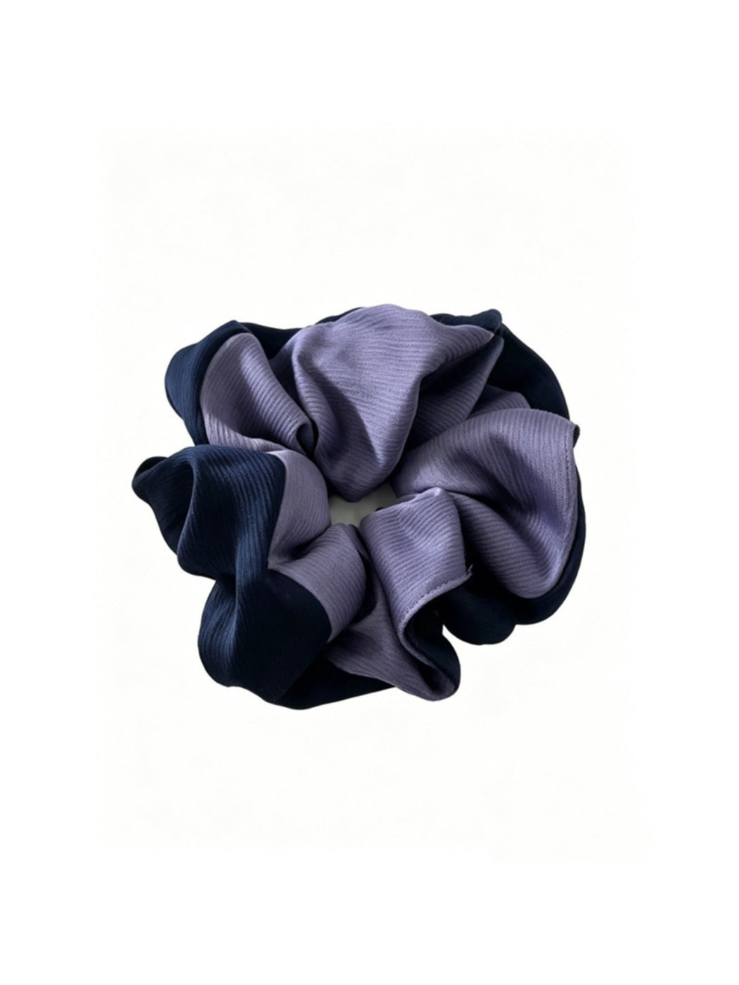 Gifty scrunchie wrapped around a ponytail on a model with brown hair