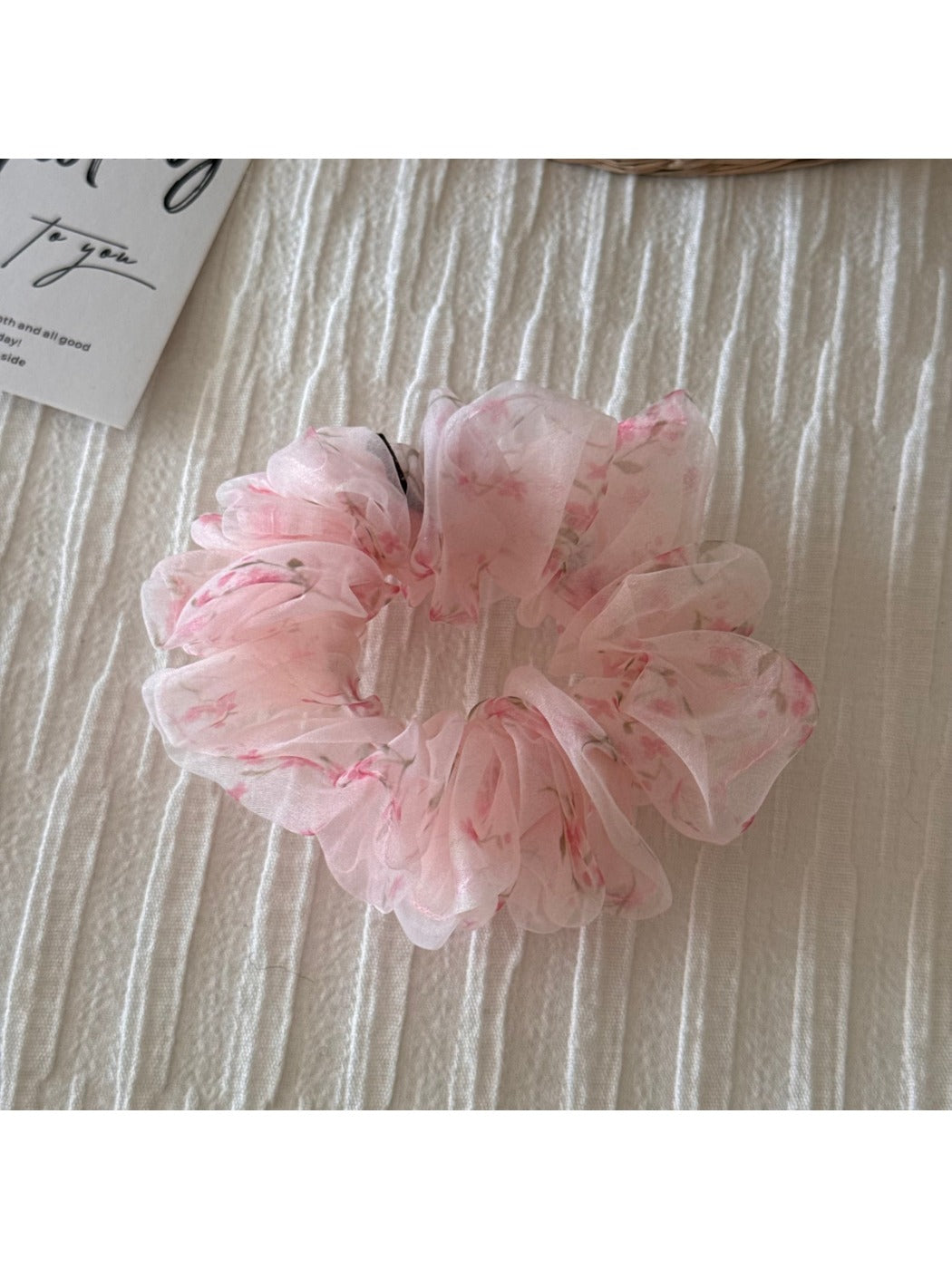 Scrunchie displayed flat highlighting multicolor floral print