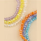 Multiple strands of Lovra beaded bracelet displayed on white background