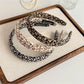 Gifty fabric headband with tiny floral print on a white background