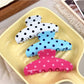 Side view of Beau polka dot half circle claw clip highlighting curved shape