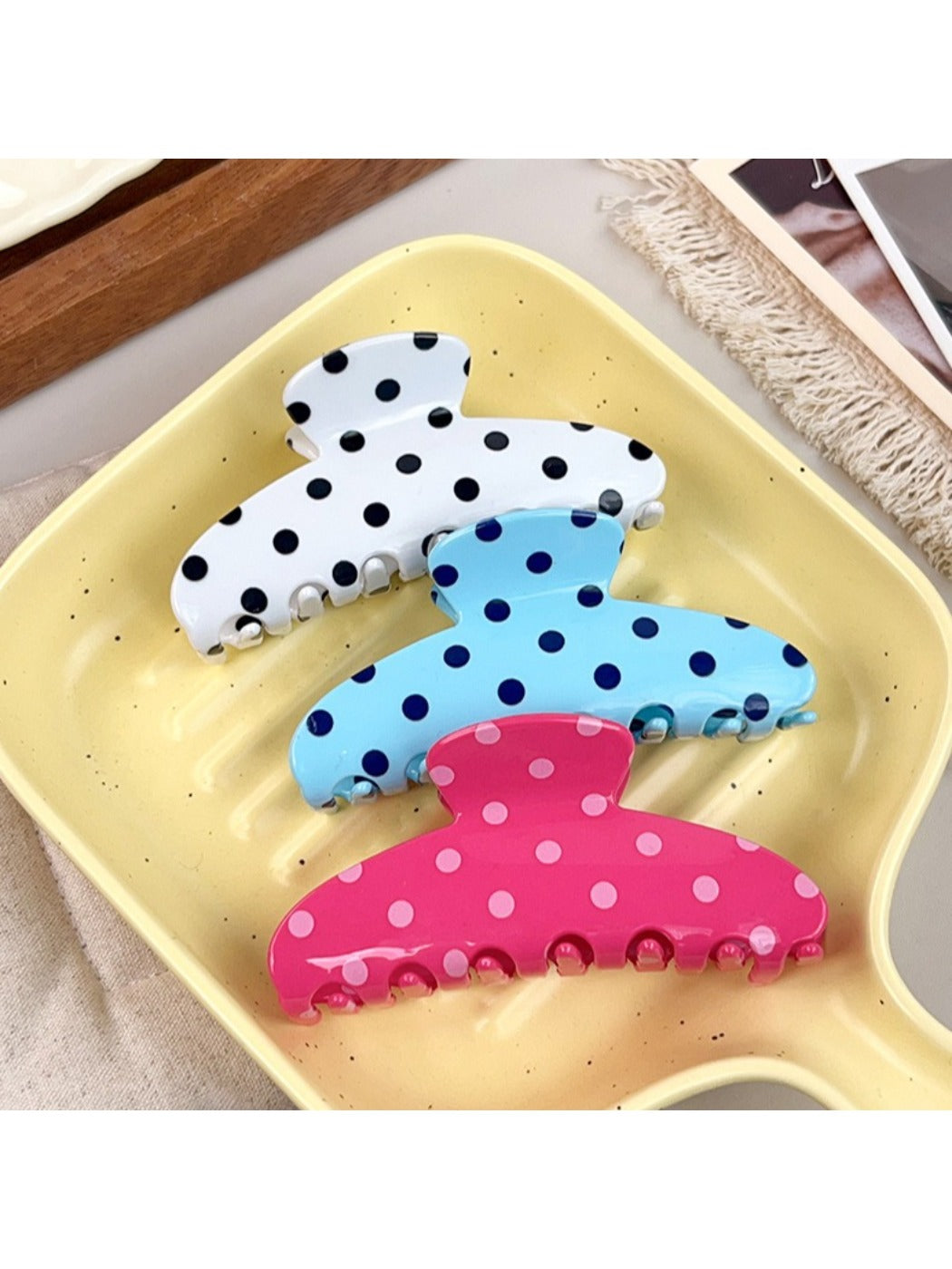 Side view of Beau polka dot half circle claw clip highlighting curved shape