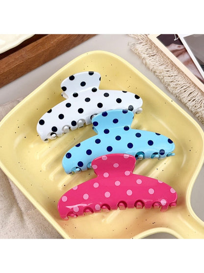 Side view of Beau polka dot half circle claw clip highlighting curved shape