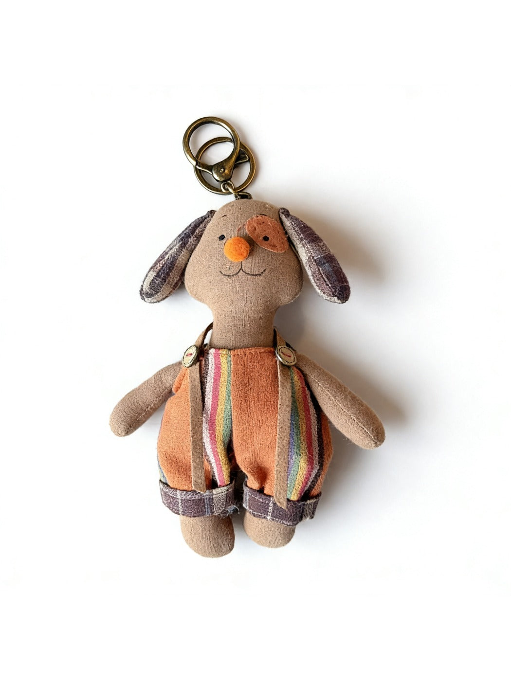 Fabric puppy keychain placed next to a smartphone for size comparison