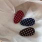 Beau oval hair clip showing metal clasp mechanism on the back