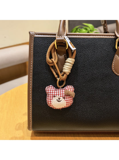 Top view of the bear charm keychain highlighting the metal keyring attachment