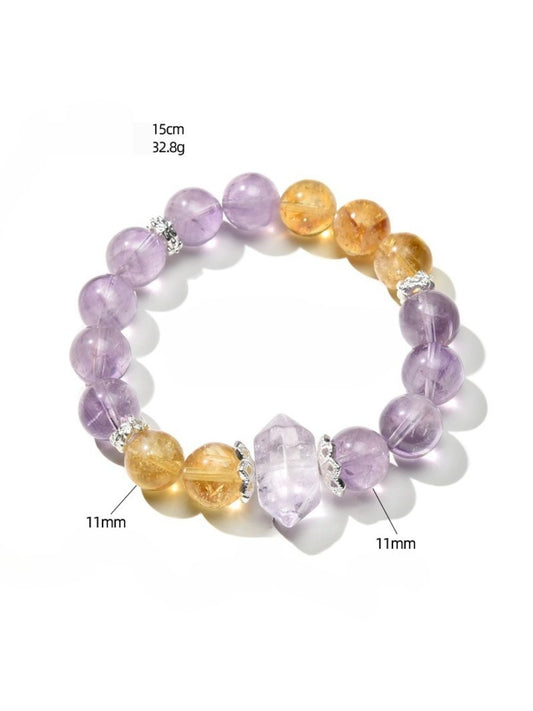 Close-up of Lovra purple and yellow crystal beaded bracelet on white background
