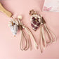 Close-up of plaid fabric strawberry umbrella keychain showing detailed stitching