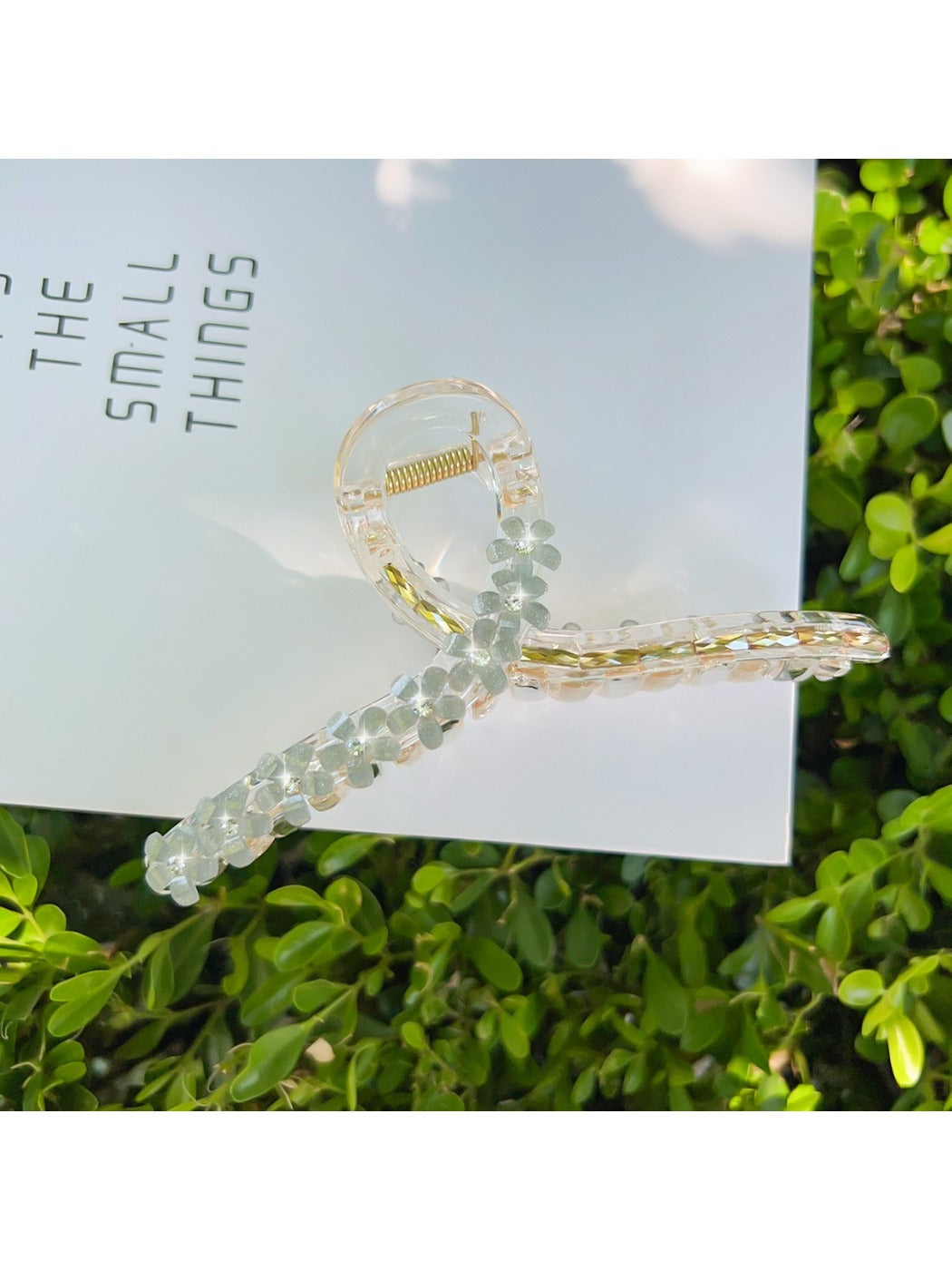 Beau flower crisscross hair claw clip on model's hair in natural light