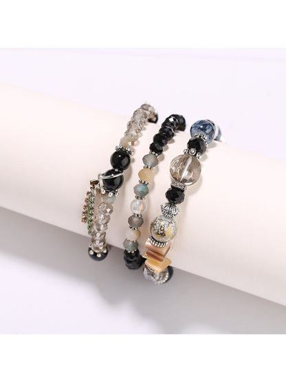 Lovra elegant beaded bracelet styled with matching jewelry on model's arm
