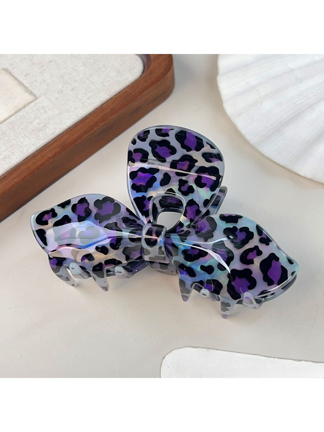 Beau hair claw clip styled in model's hair showing leopard print bow