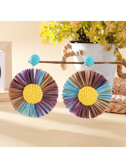 Close-up of the back of a raffia sunflower earring showing the metal clasp