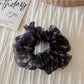 Scrunchie displayed with matching floral accessories