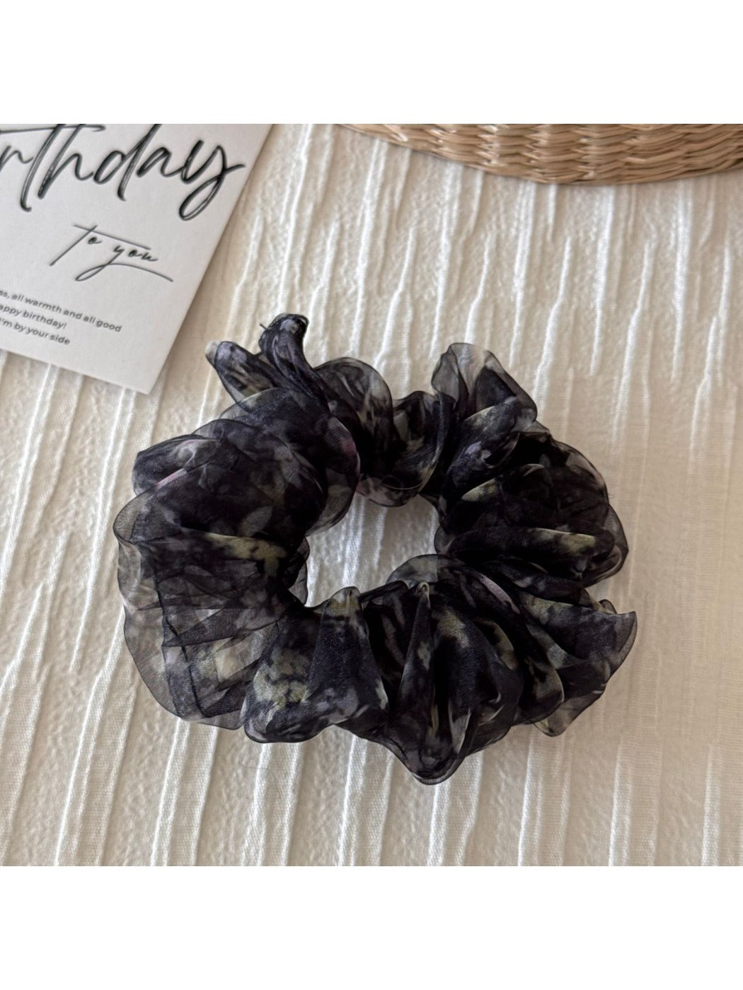 Scrunchie displayed with matching floral accessories