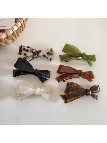 Close-up of Beau hair clip showing textured fabric and bow shape
