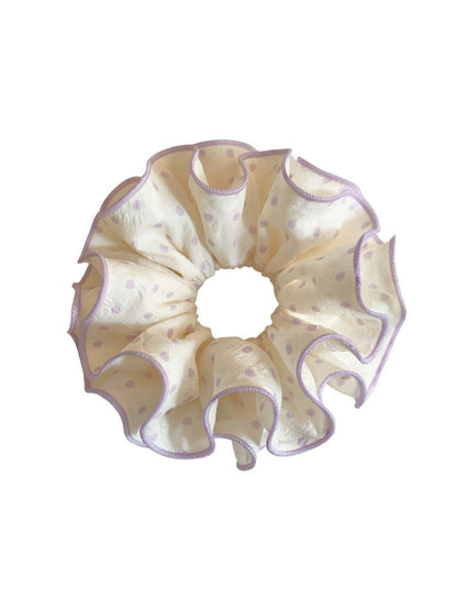 Side view of purple polka dot scrunchie showing fabric texture