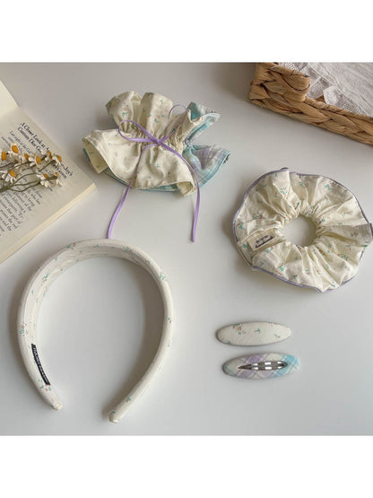 Close-up of Gifty scrunchie headband showing gathered fabric texture in beige