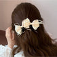 Beau Sweet Bow Banana Clip worn in long hair, styled in a half-updo