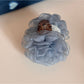 Beau rose hair clip held between fingers showing size