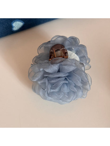 Beau rose hair clip held between fingers showing size