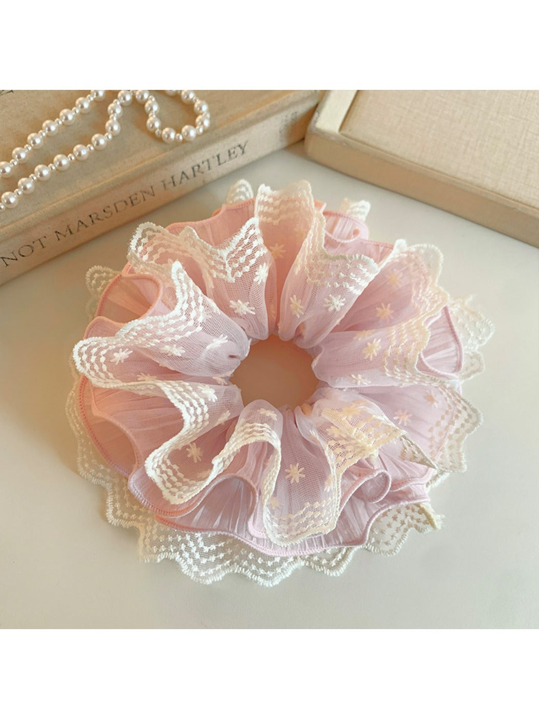 Gifty ruffled scrunchie worn on a wrist showing soft fabric and print details