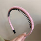Gifty headband shown in multiple solid color options on display