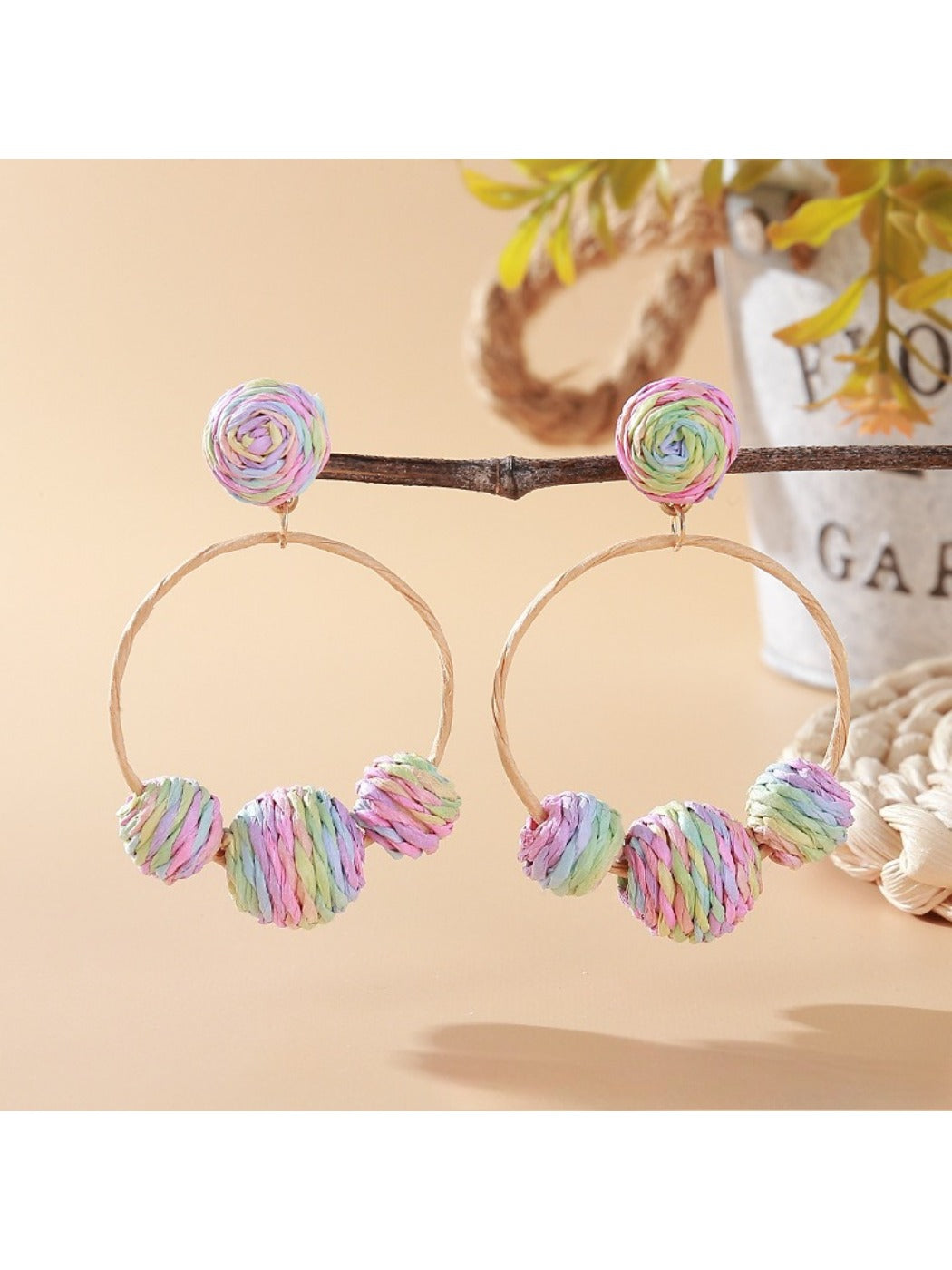 Side view of Earedge raffia round ball earrings showing texture and shape
