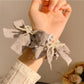 Gifty lace bow polka dot scrunchie displayed on a white background
