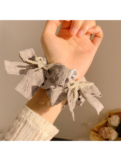 Gifty lace bow polka dot scrunchie displayed on a white background