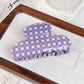 Top view of purple plaid hair claw clip highlighting fabric texture