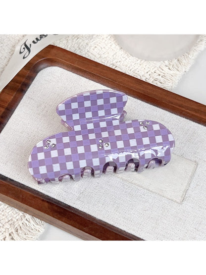 Top view of purple plaid hair claw clip highlighting fabric texture