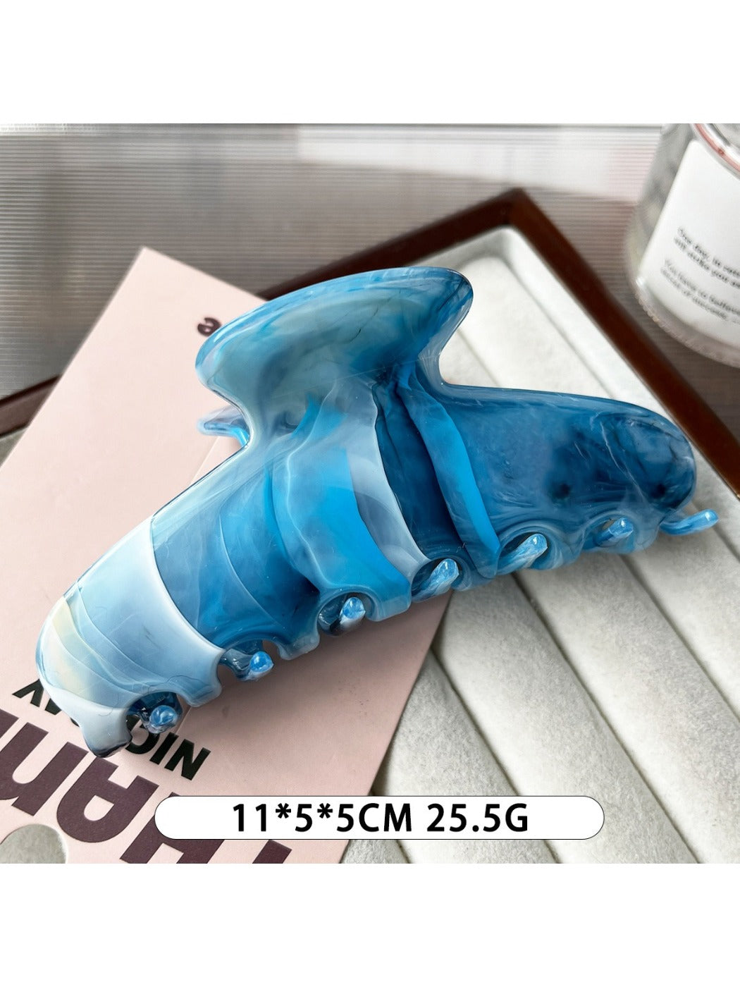 Beau plastic updo claw clip holding a twisted hair bun on a model