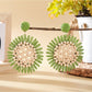 Pair of gold sunflower shaped drop earrings arranged with green leaves