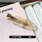 Beau acetate invisible hair clip photographed with soft natural lighting