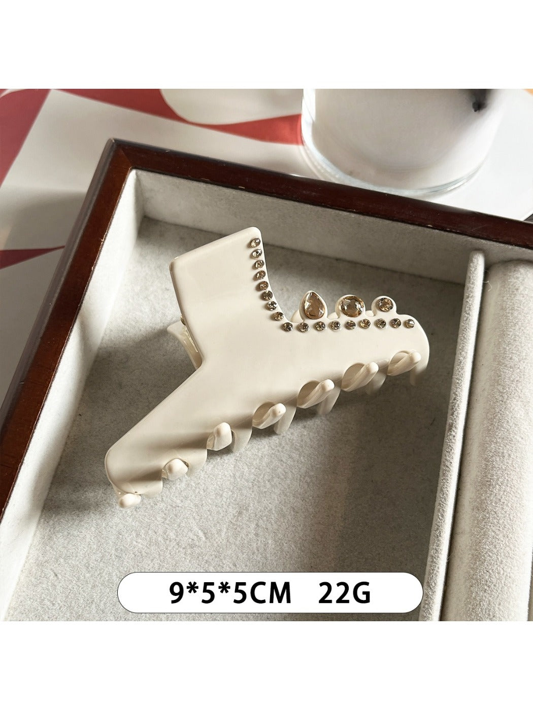 Beau rhinestone embellished claw clip displayed on a textured surface
