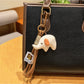 Elephant charm keychain alongside other animal-themed keychains