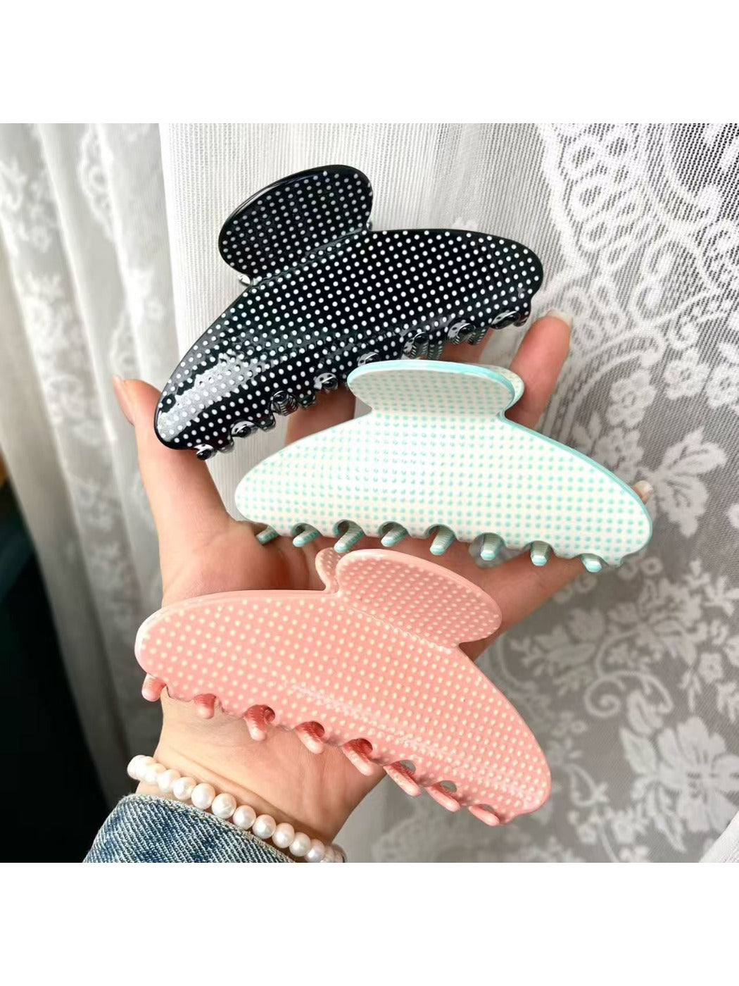 Close-up of Beau polka dot acetate claw clip highlighting pattern and texture