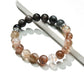 Close-up of Lovra Crystal Obsidian Beaded Bracelet with polished black beads on a white background