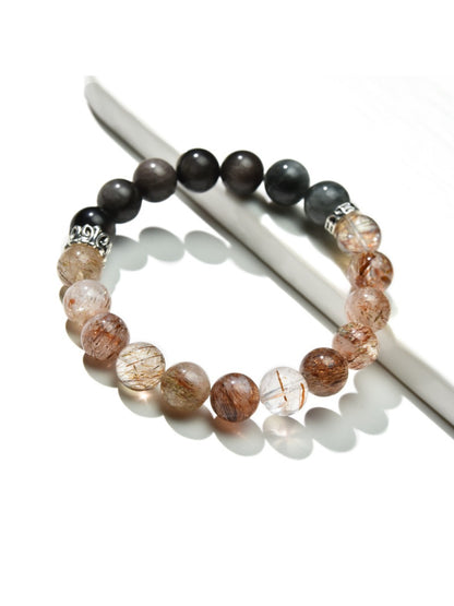 Close-up of Lovra Crystal Obsidian Beaded Bracelet with polished black beads on a white background