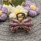 Side view of Beau pleated bow hair clip clipped into dark hair