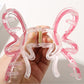 Top view of pastel butterfly hair clip showing detailed wing design