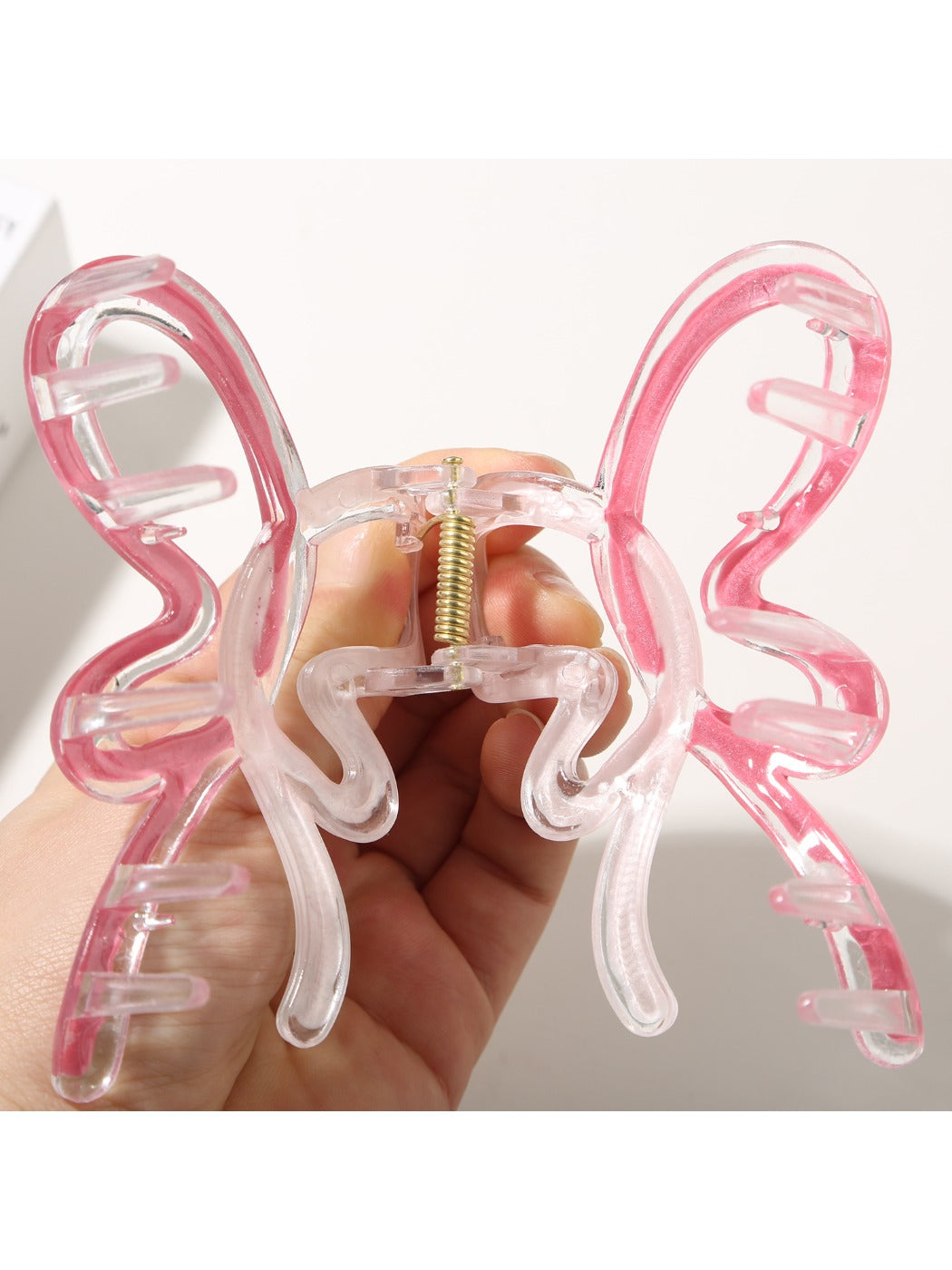 Top view of pastel butterfly hair clip showing detailed wing design