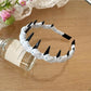 Gifty Sweet Polka Dot Headband displayed flat with bow centered
