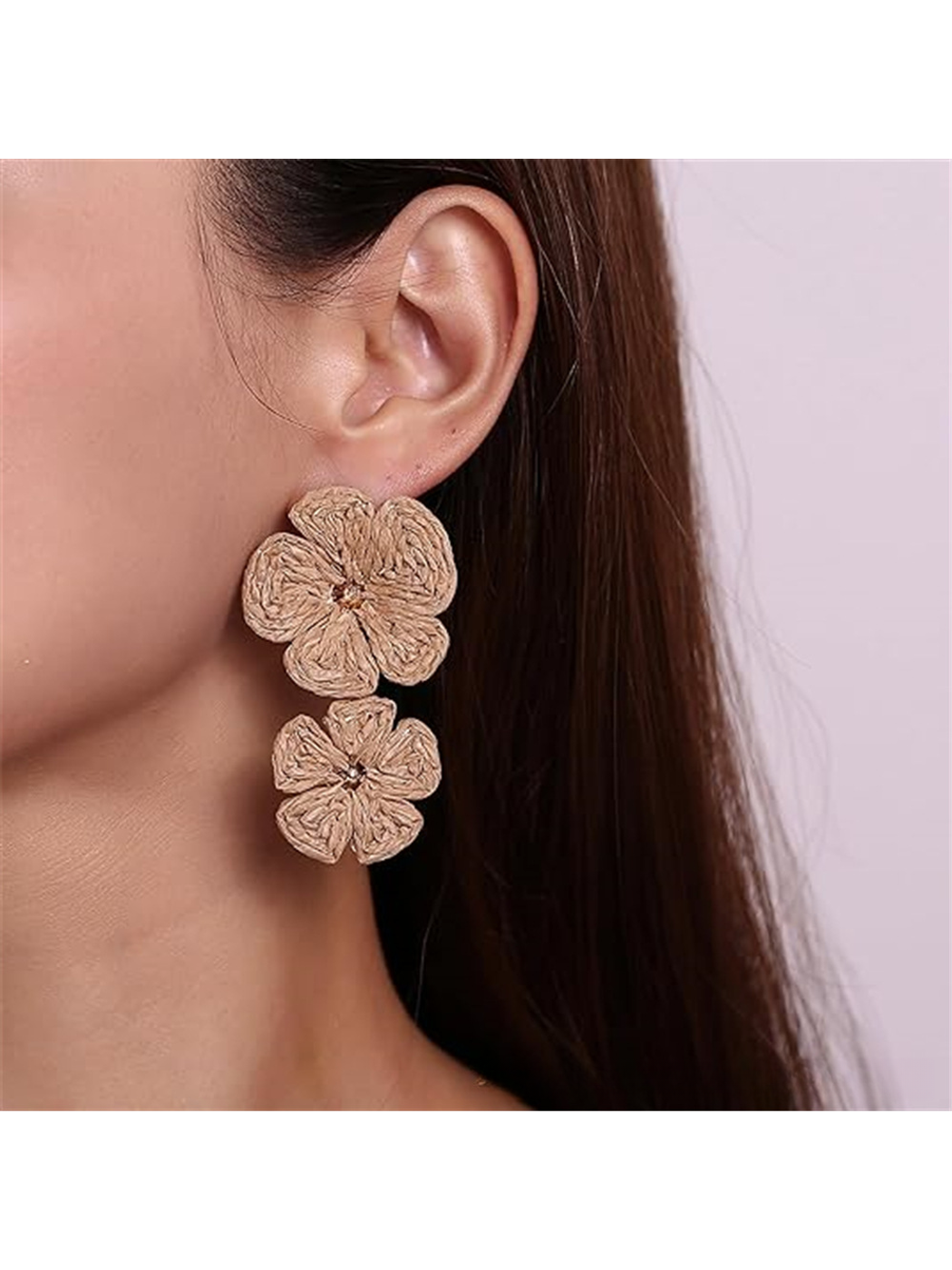 Earedge floral pendant raffia drop earrings hanging on a jewelry stand