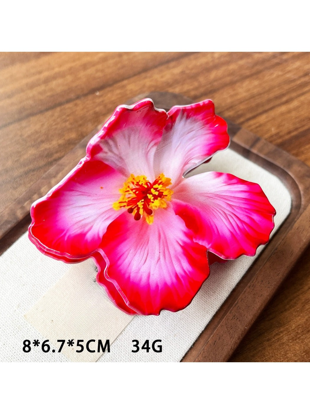 Beau hibiscus claw clip in natural light emphasizing lifelike flower details