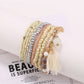 Lovra bracelet draped over a white surface showing bead colors and shine